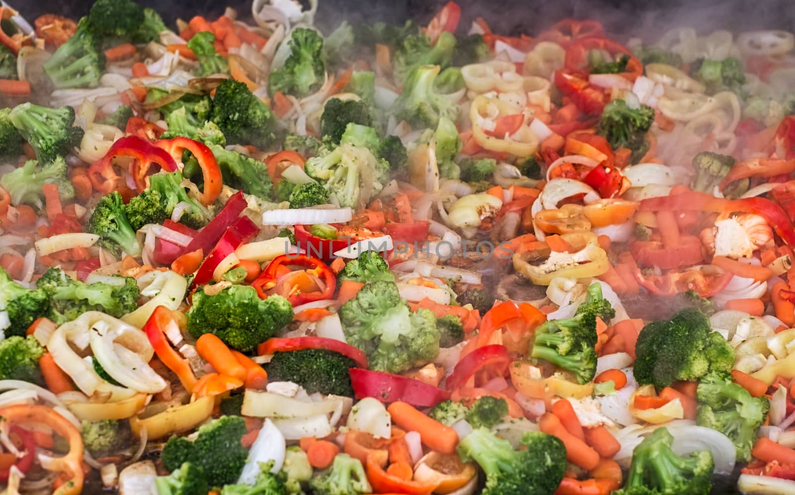 fresh vegetables steaming on iron pan