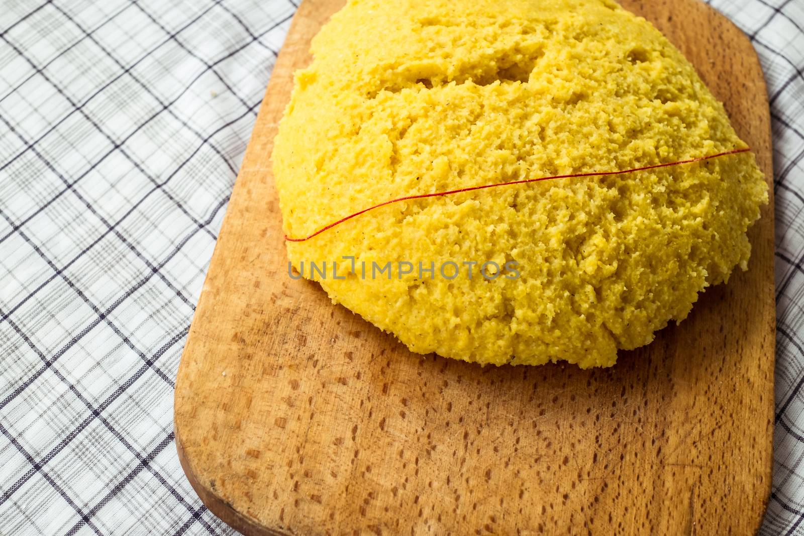Hot steaming polenta on a old wooden board