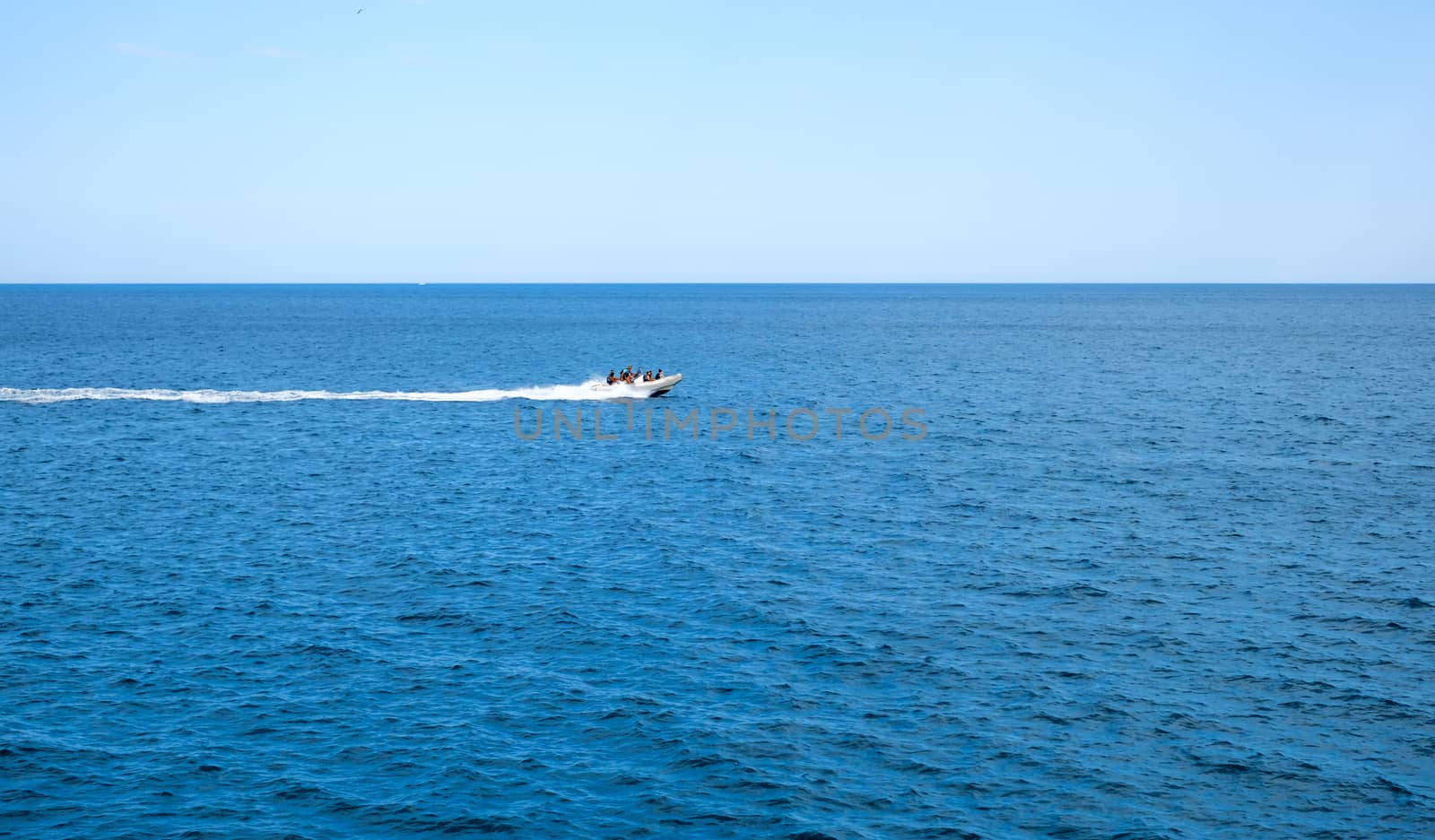 inflatable rib boat cruising in high speed in clear water sea