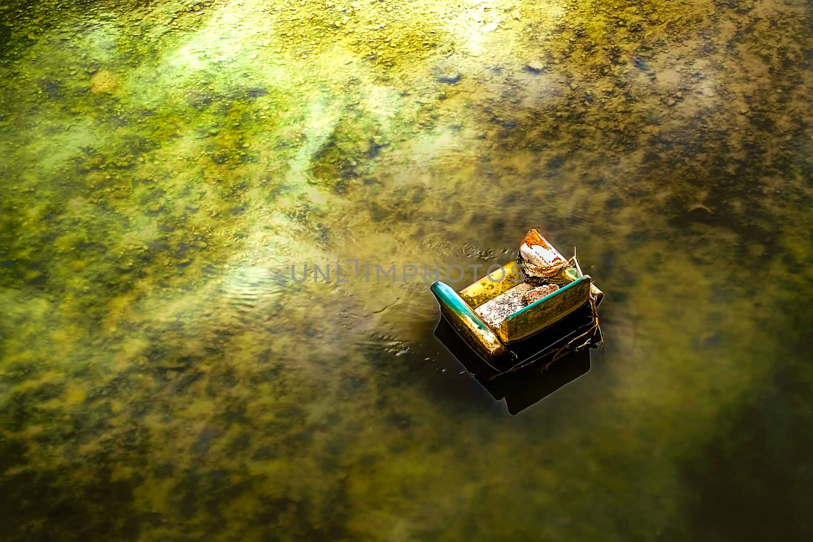 the armchair abandoned in the river