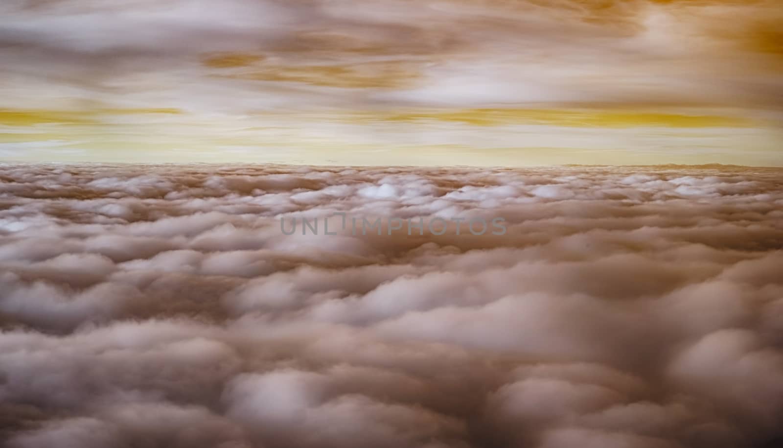 View over the clouds from airplane, infrared filter