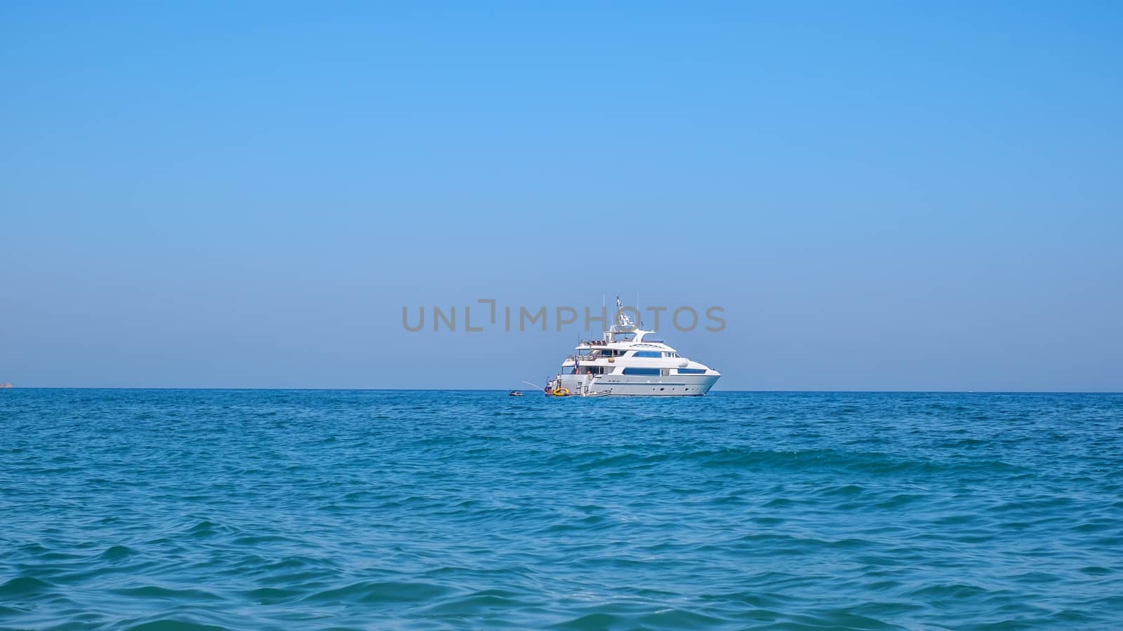 white yacht on the open sea and clear sky