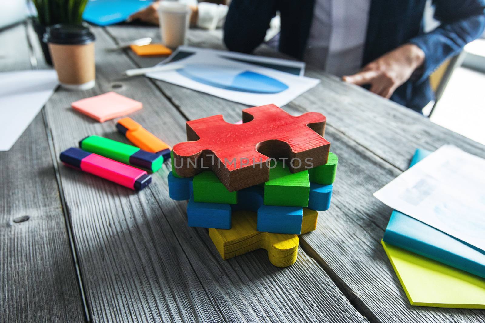 Puzzle pieces on office meetng table, business vision and problem solution concept