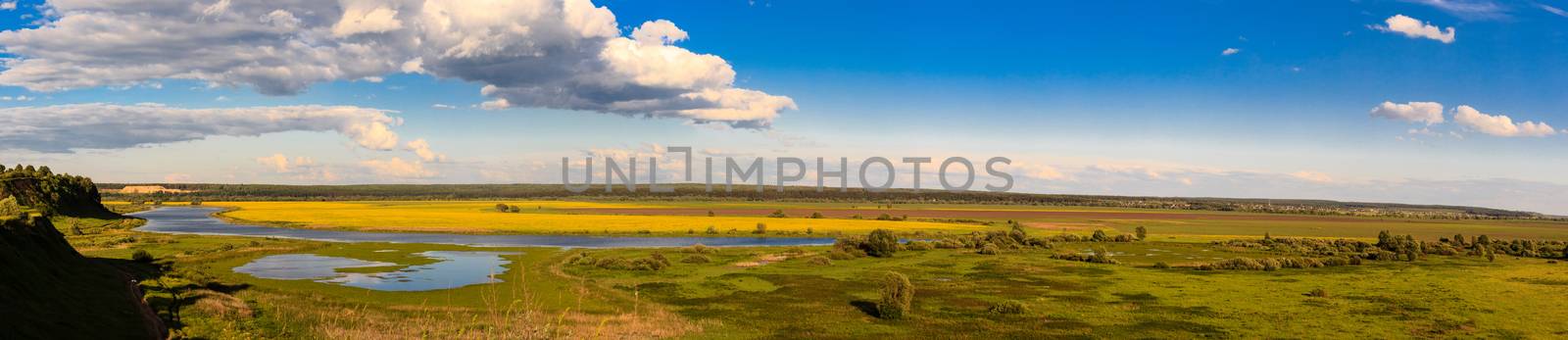 Summer landscape with river and cloudy sky, panorama