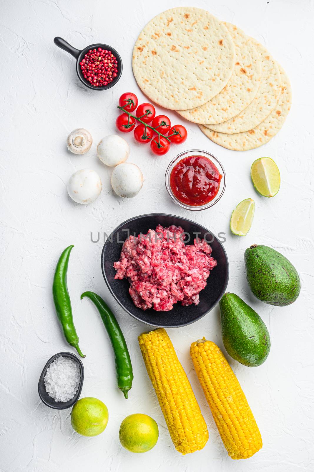 Taco ingredients homemade authentic mexican beef meal, over white concrete background top view