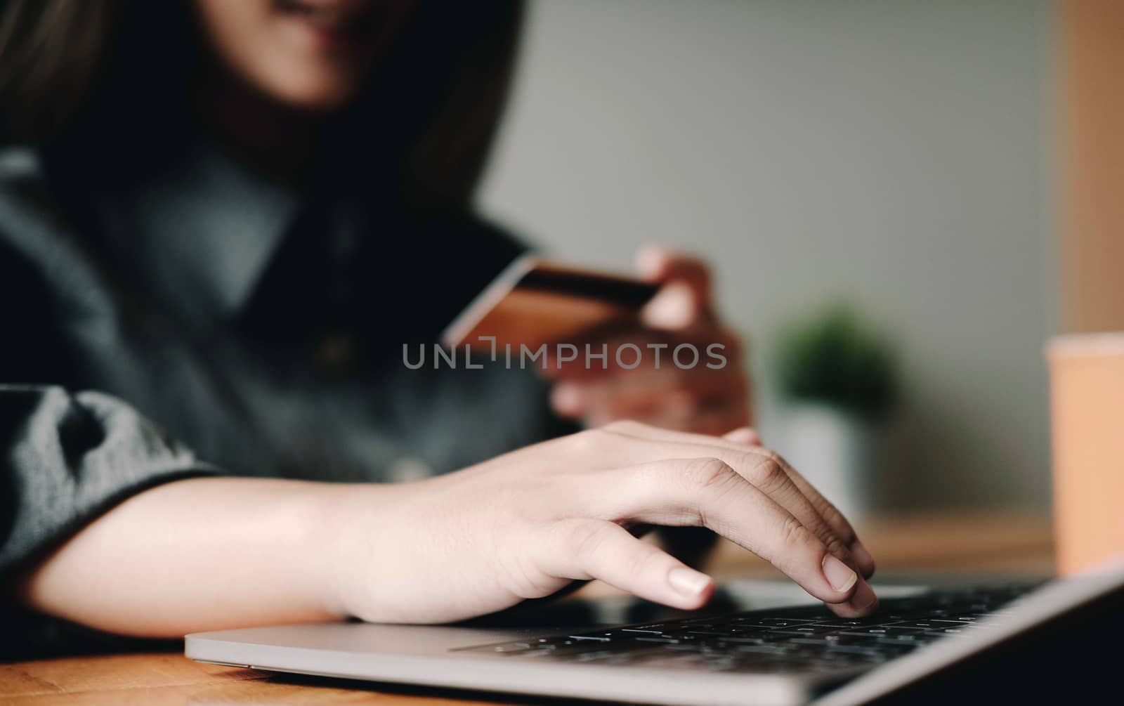 Online payment, digital banking. woman hand using credit card for online shopping via laptop computer on table.