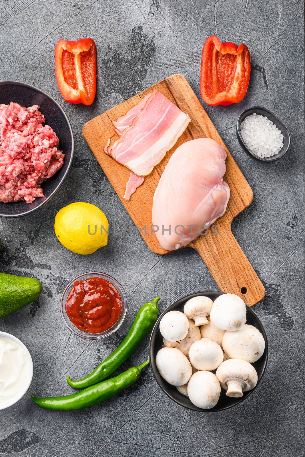Ingredients for chicken meat mexican tacos , corn tortillas, chili pepper, avocado, meat on textured grey background, top view