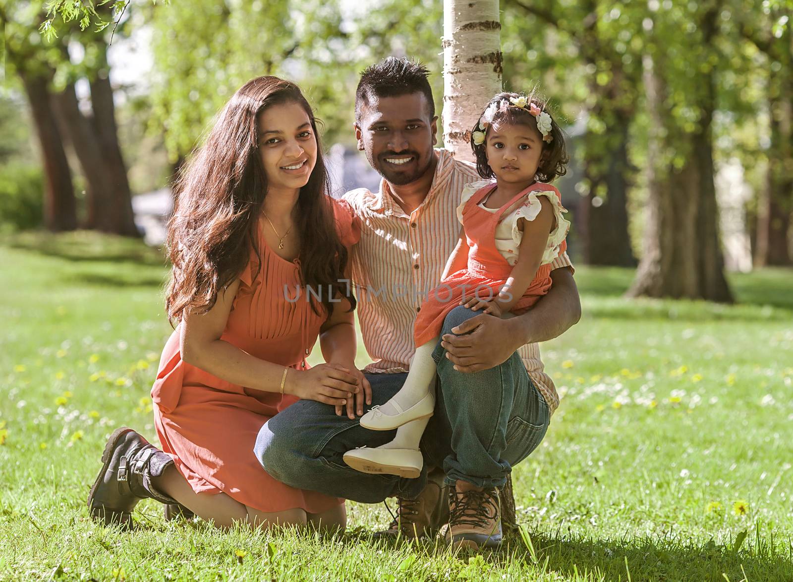 happy married couple with a little daughter in a summer Park