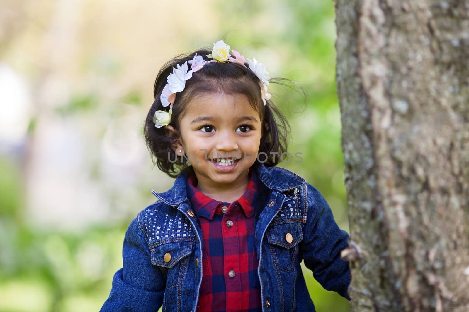 A smiling two years old girl is playing in park by anry