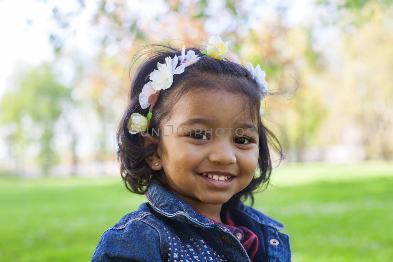 portrait of a little happy girl in spring park