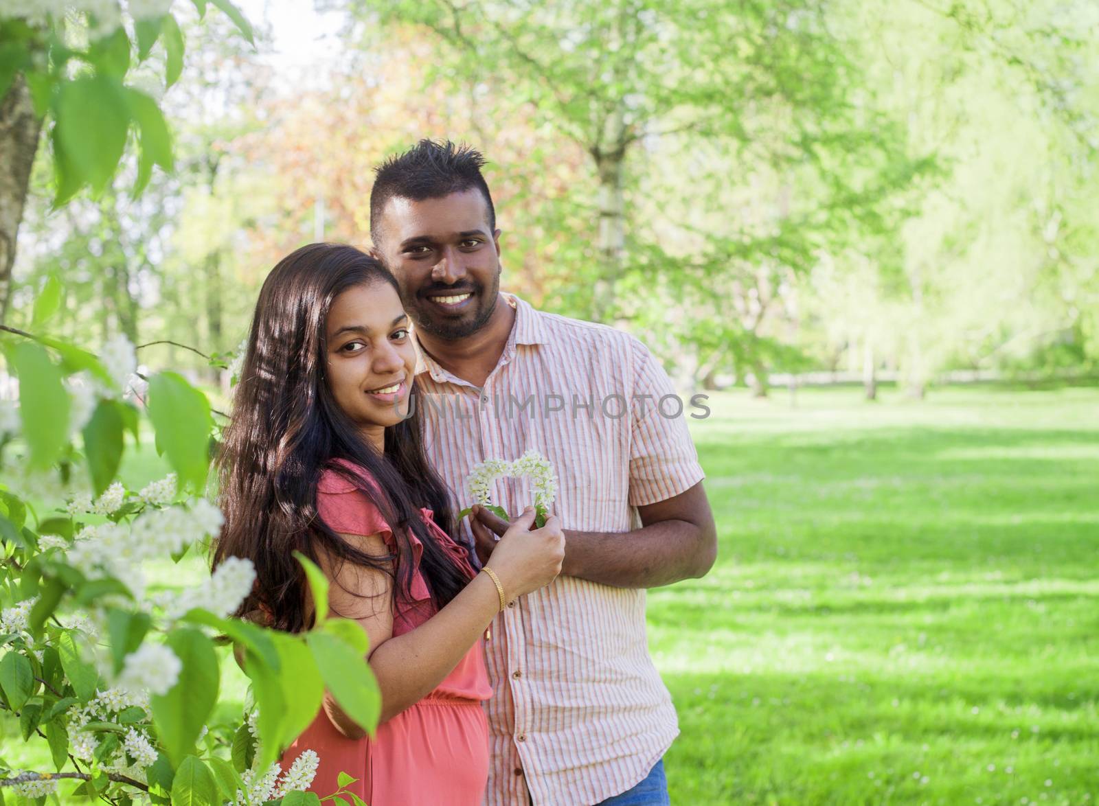 happy Asian couple in city park by anry