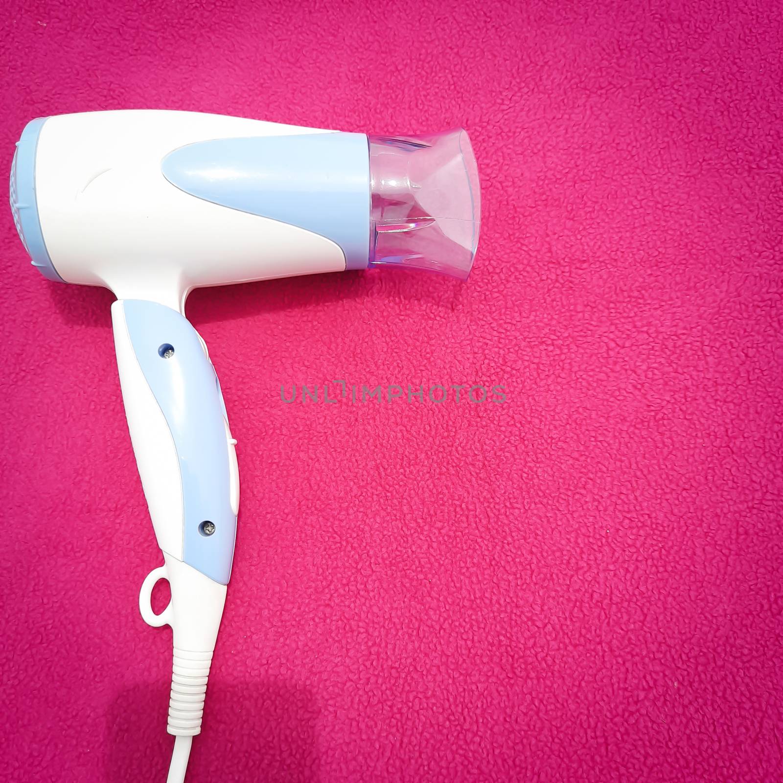 Hair dryer beautifully placed in pink background