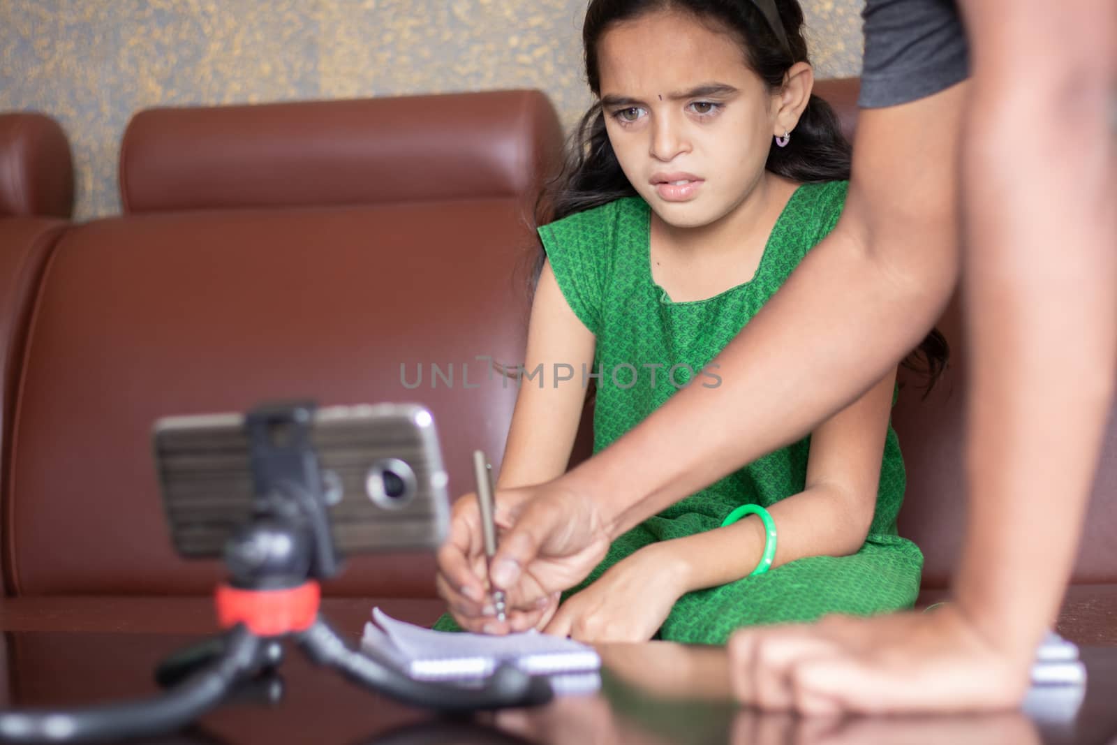 Father helping daughter by solving problem while studying the lesson from online class or e-learning - concept of Role of parents in supporting child during homeschooling, distance learning