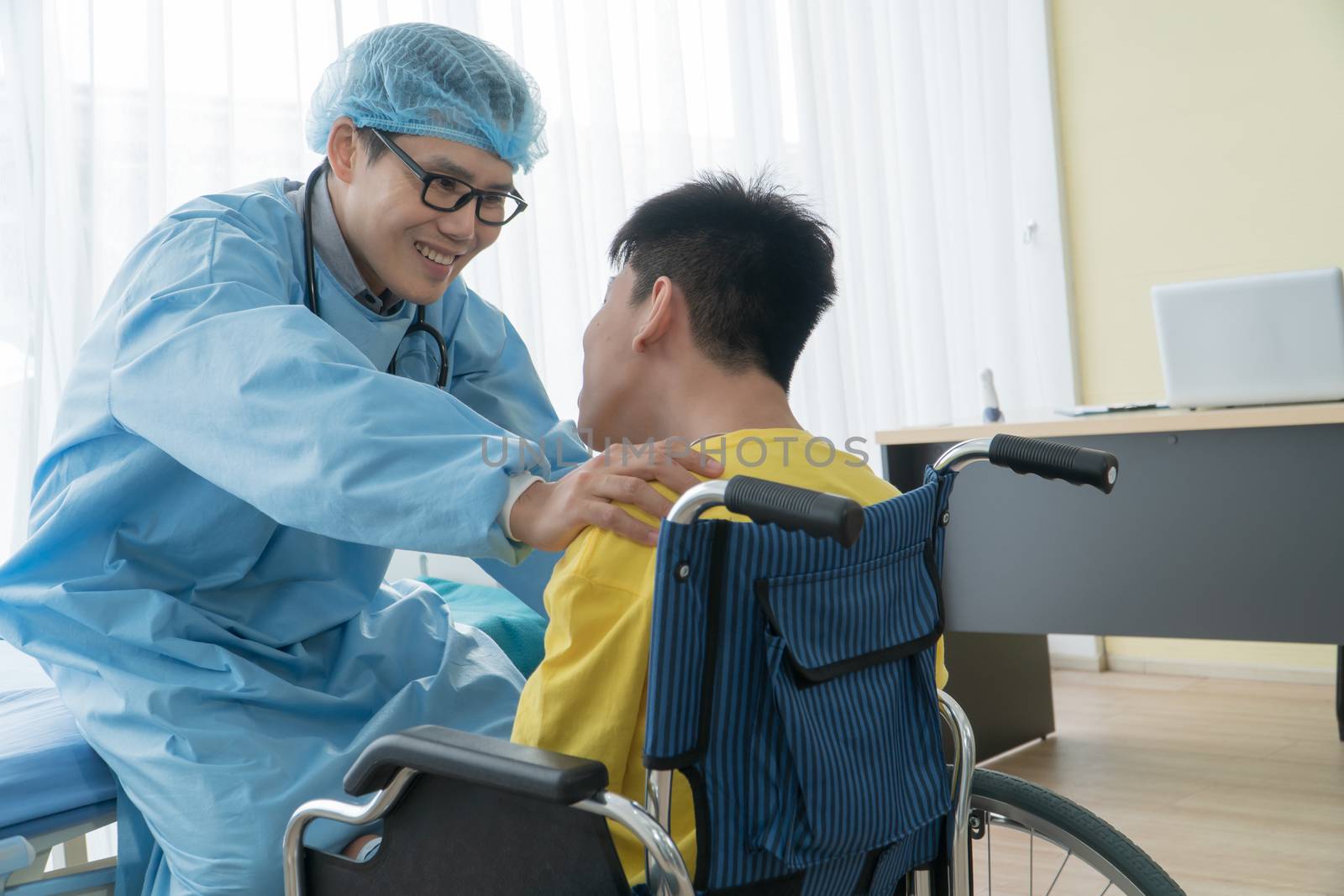 Asian Volunteer Doctors Caring and Helping Rehabilitation of Disabled Boys Stay at the hospital. The boy is crippled, Asian people can't help themselves. Must sit in a wheelchair all the time