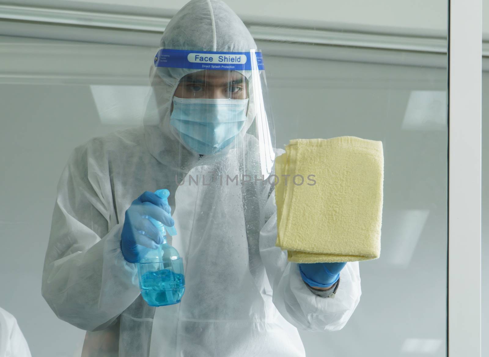 Workers wear protective clothing and wear a mask. Spraying disinfectants for cleaning inside the building. Cleaning service professionals are becoming popular After the spread of coronavirus