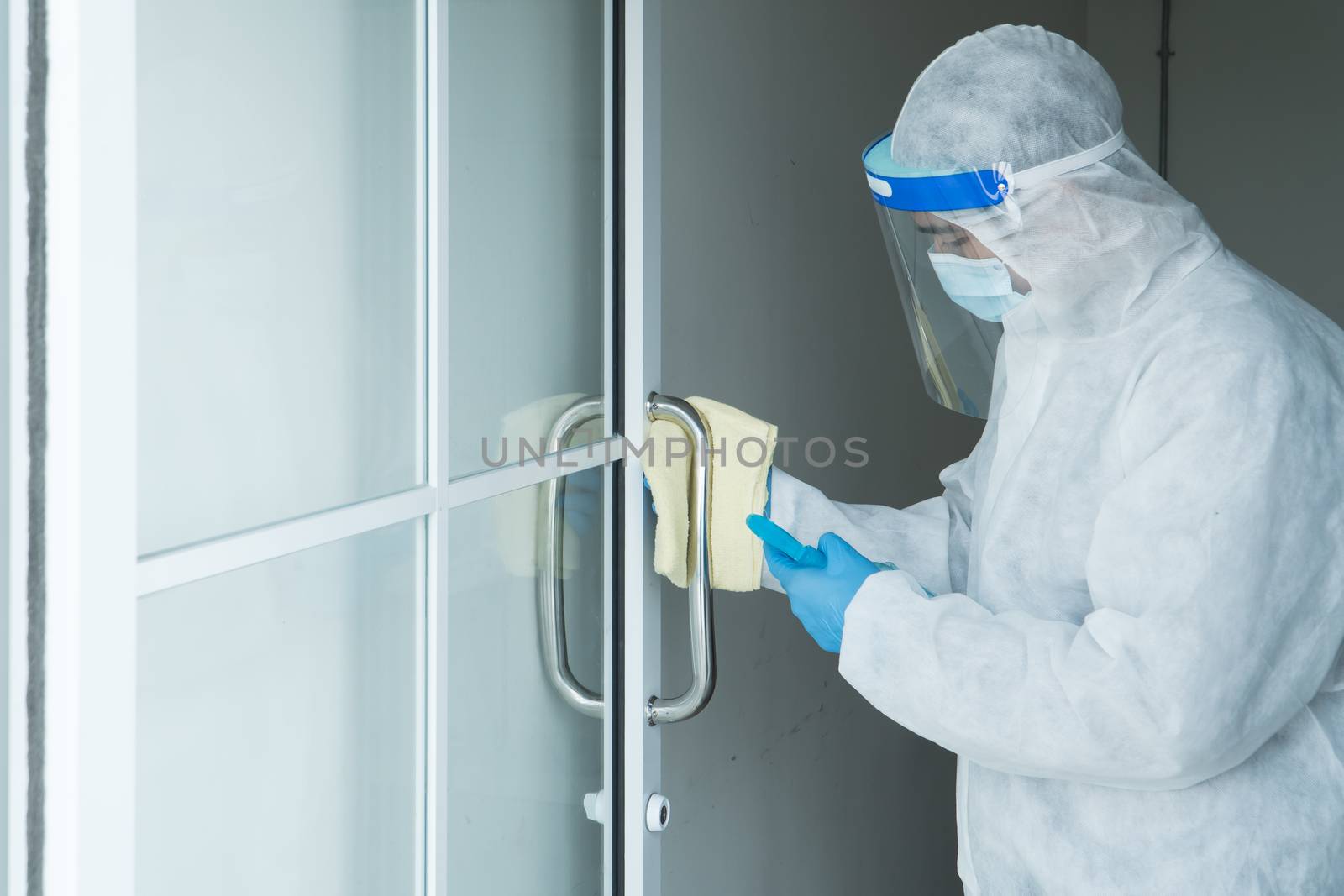 Workers wear protective clothing and wear a mask. Spraying disinfectants for cleaning inside the building. Cleaning service professionals are becoming popular After the spread of coronavirus