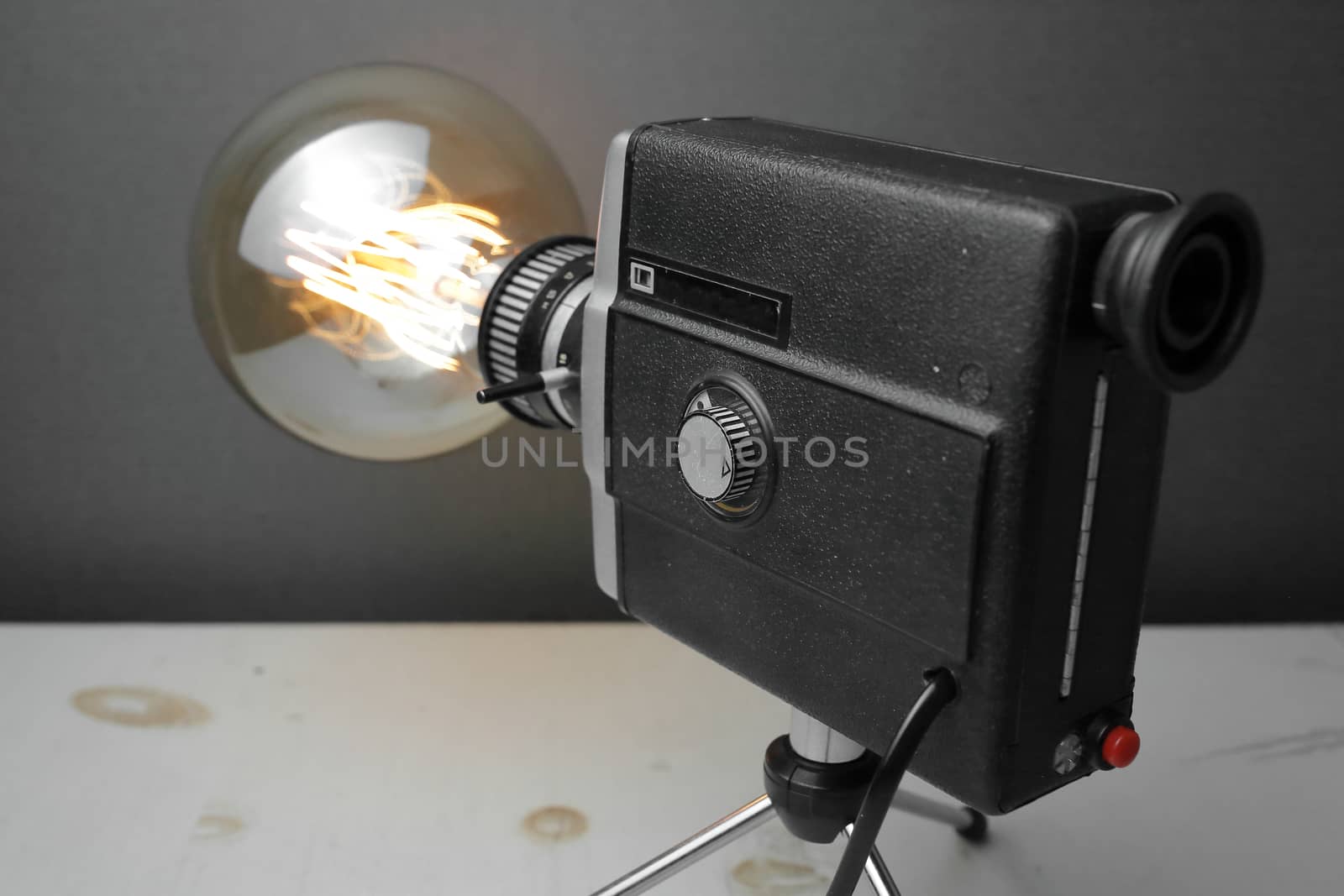 Retro lamp from an old camera with an Edison lamp on a gray background. Concept is a good idea. High quality photo