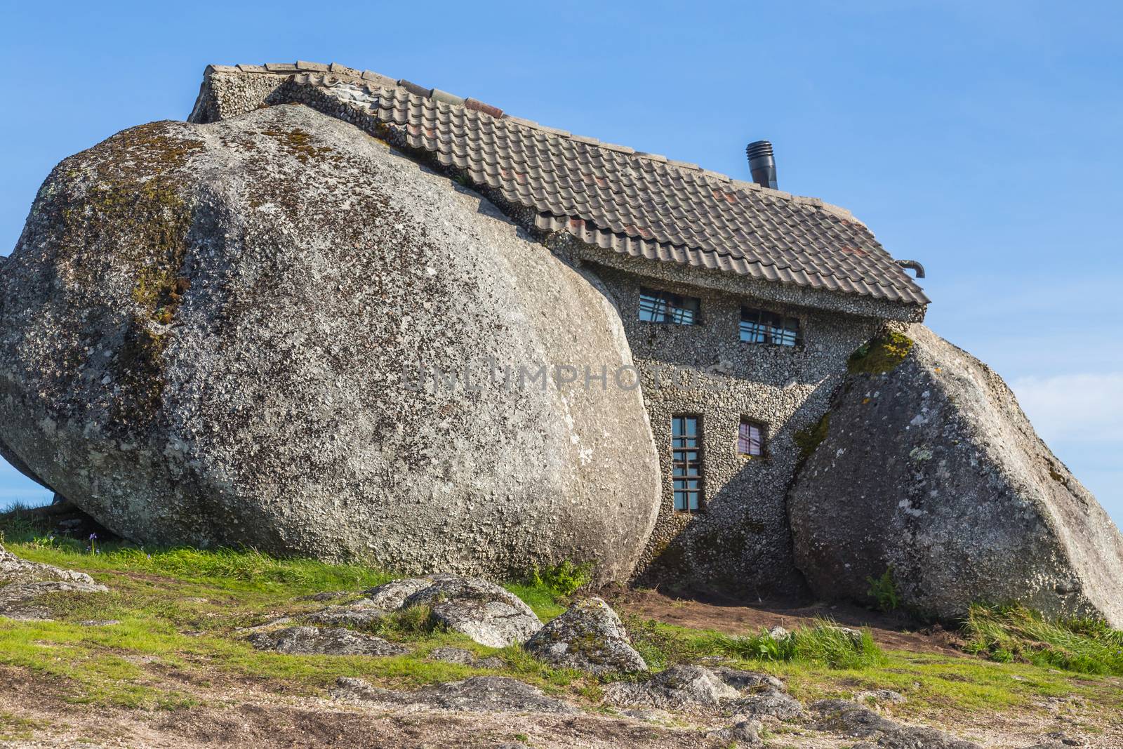 Casa do Penedo, a house built between huge rocks on top of a mountain in Fafe, Portugal. Commonly considered one of the strangest houses in the world.