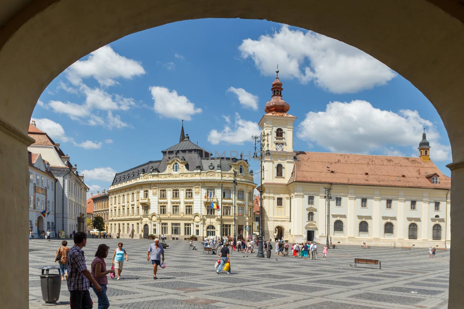 SIBIU, ROMANIA - Circa 2020: Old medieval town with cloudy blue sky. Beautiful tourist spot in eastern central Europe. Famous Big Square in Sibiu Romania by dugulan