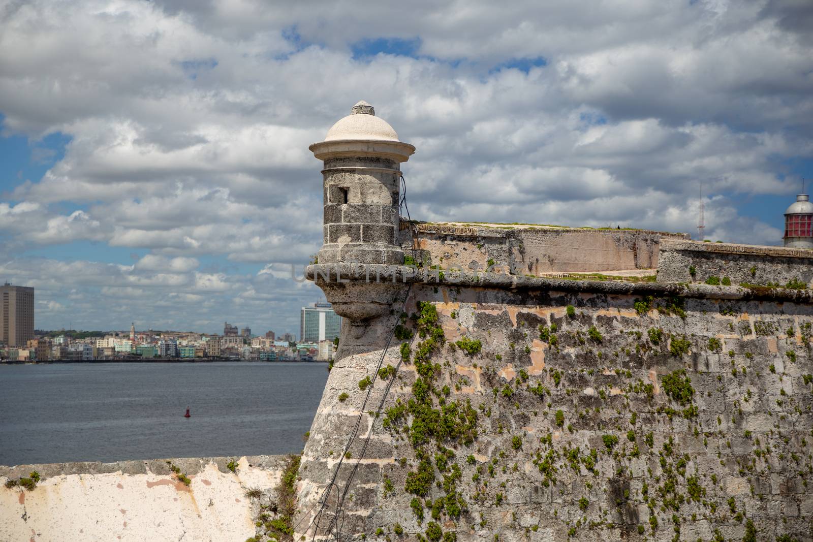 HAVANA, CUBA - CIRCA 2017: view of Havana city from Castillo de los Tres Reyes del Morro with beautiful cloudy sky. Travel and vacation must see. Old stone tower.