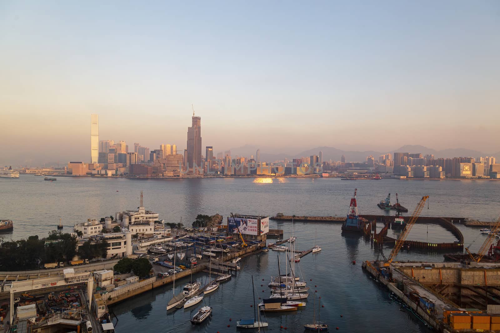 HONG KONG, CHINA - CIRCA 2020: Hong Kong Skyline and Victoria Harbor in morning. Sunset over Hong Kong bay on a clear day by dugulan