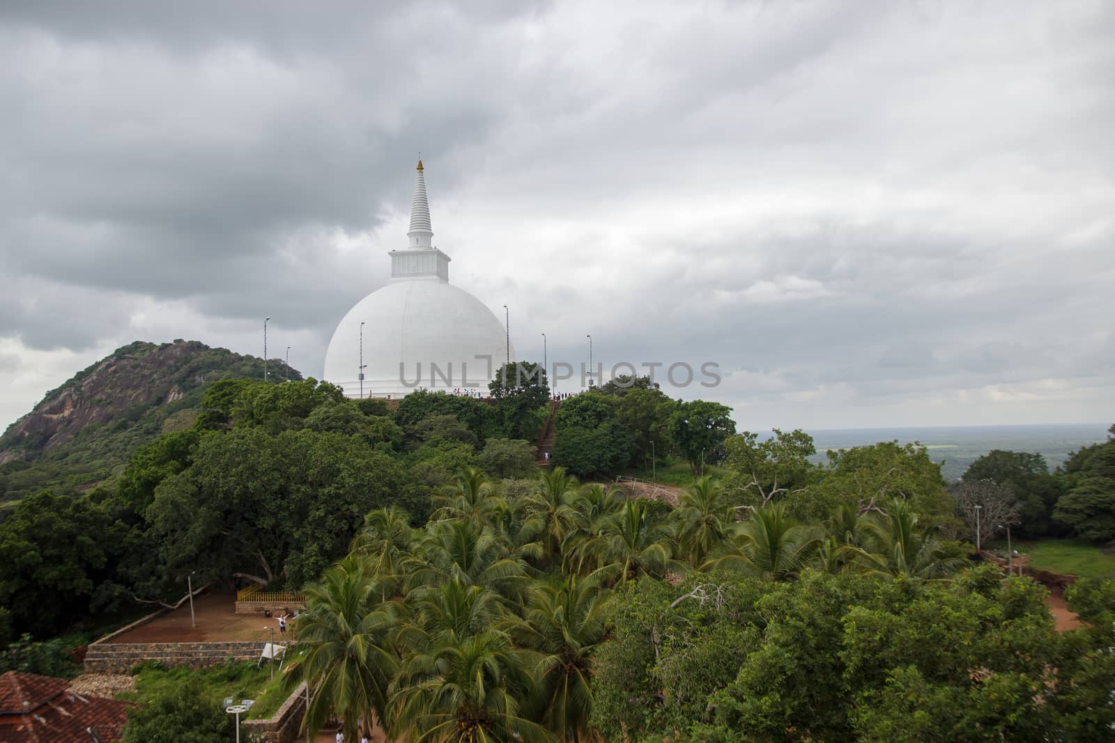 Mihintale, Sri Lanka - CIRCA 2018: Big white Buddha statue against blue sky in Mihintale, the cradle of buddhism at Sri Lanka