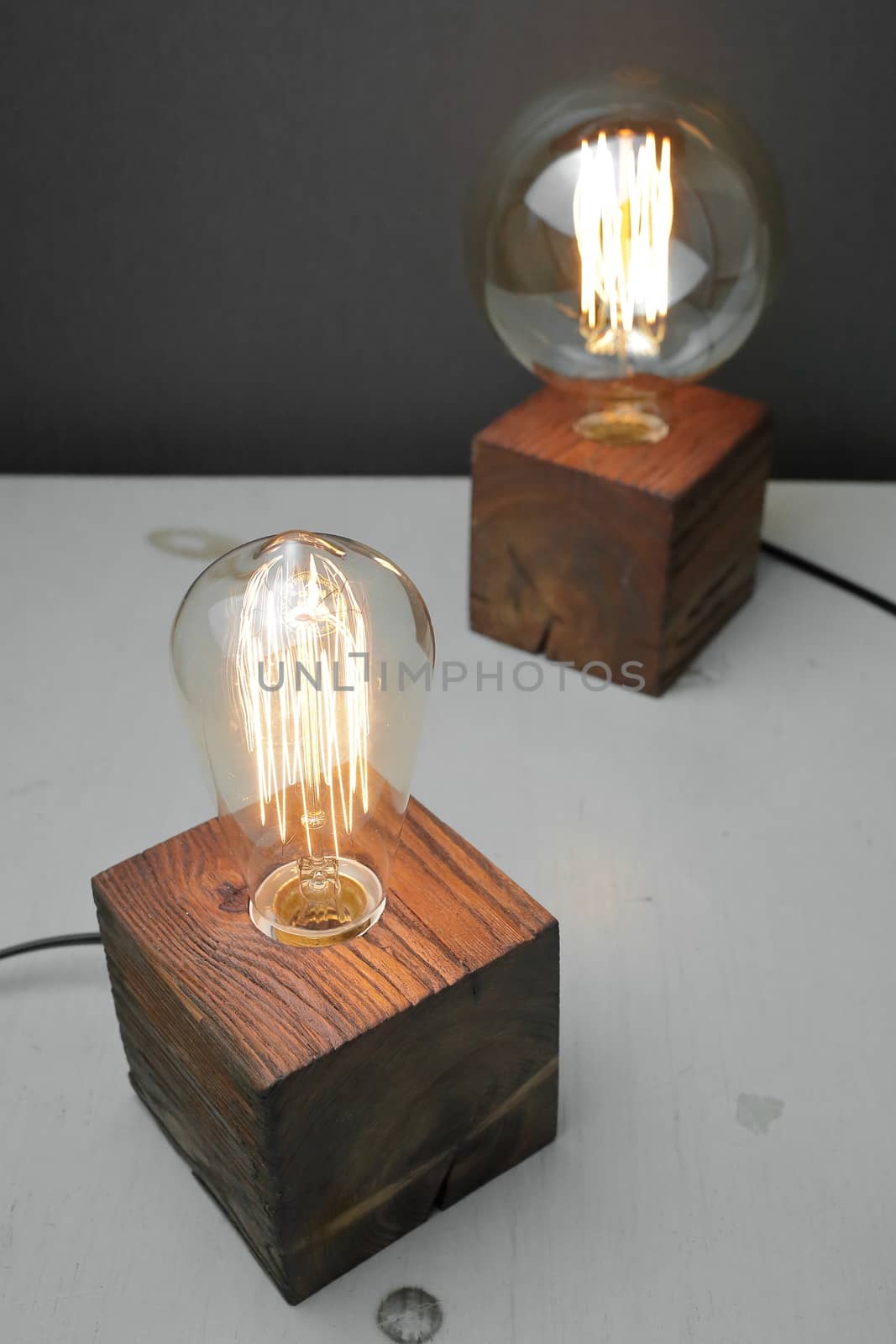 Retro wood lamp with Edison lamp on a gray background. The concept is a good idea. by selinsmo