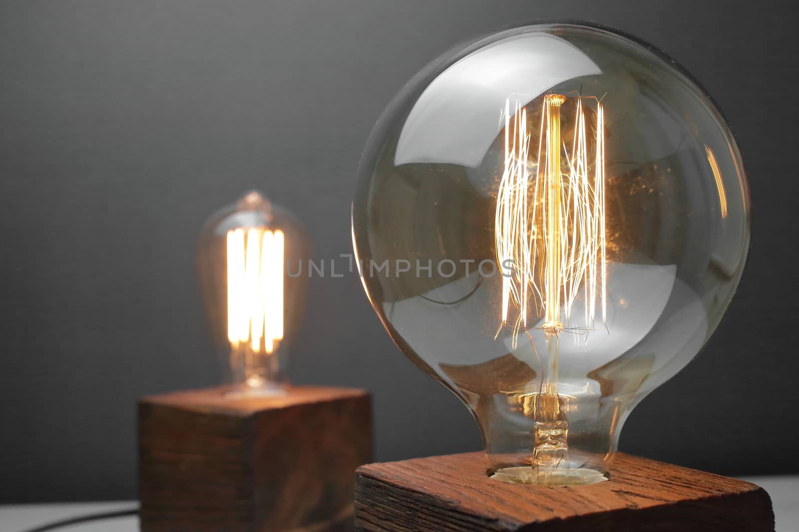 Retro wood lamp with Edison lamp on a gray background. The concept is a good idea. by selinsmo