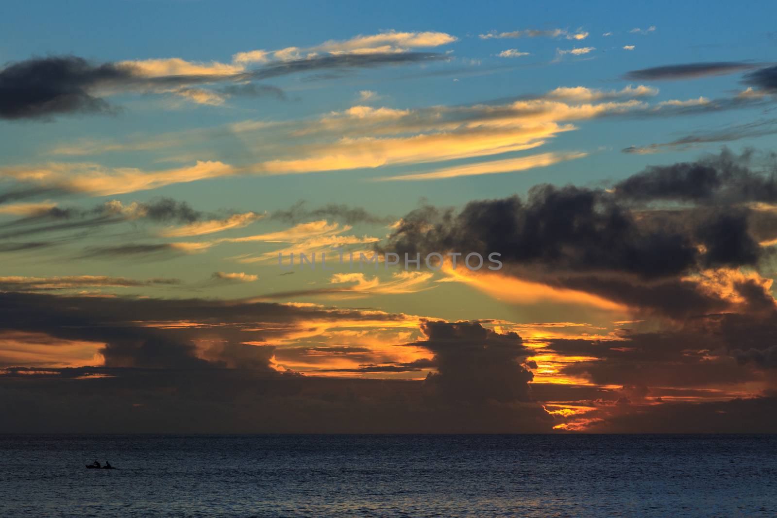 Landscape beautiful colorful golden sunset red and orange sky Seychelles. Serenity and calm concept. The sun sets behind the horizon on a cloudy day.