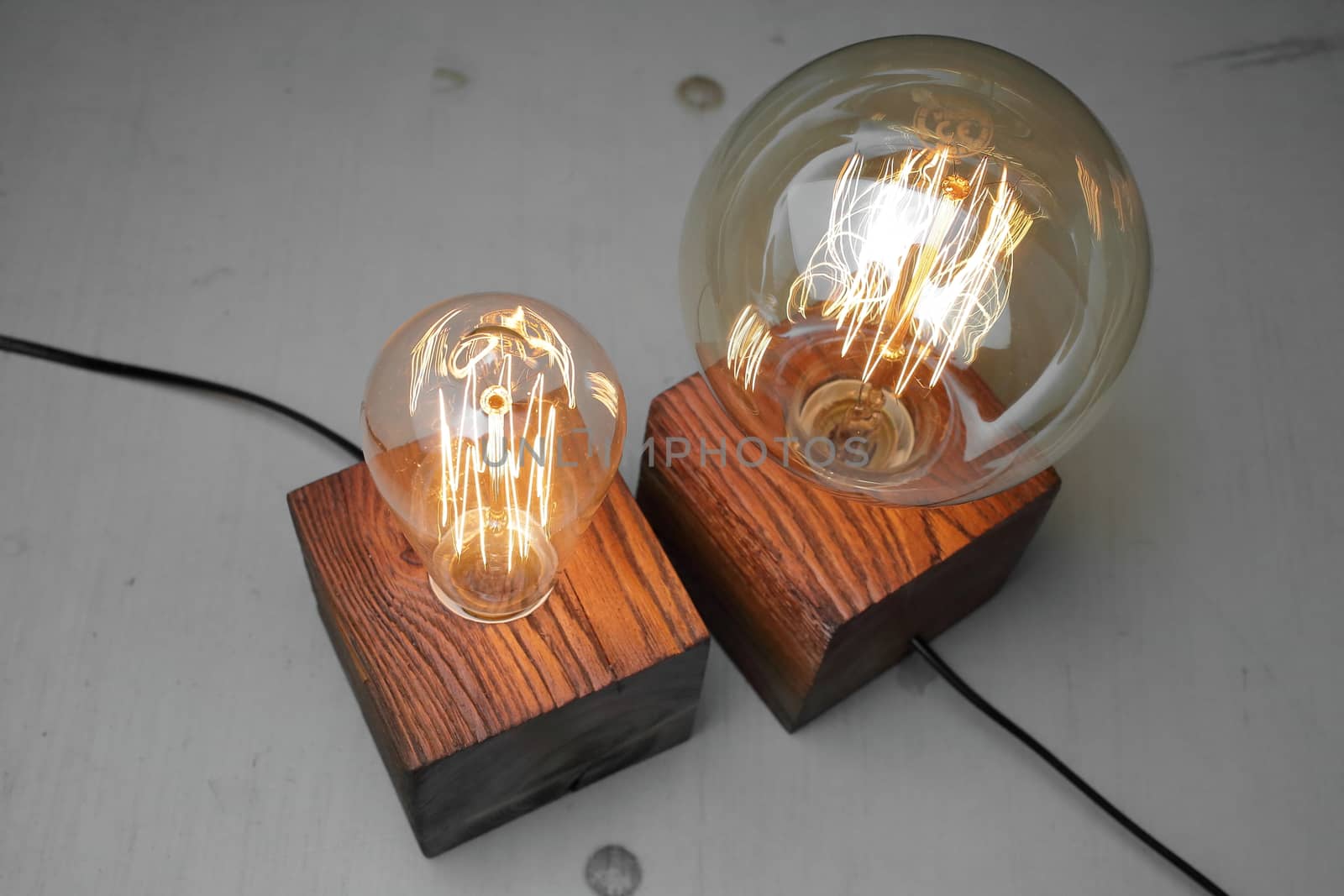 Retro wood lamp with Edison lamp on a gray background. The concept is a good idea. High quality photo