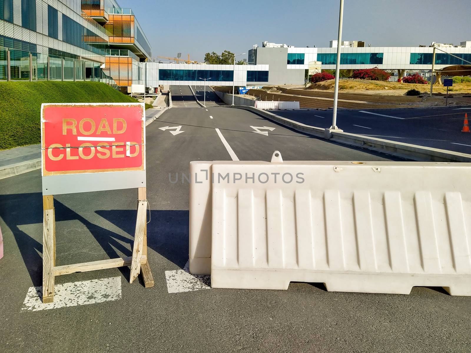 Dubai, UAE - CIRCA 2020: Road closer sign and road blockade near a hospital. Concept of road diversion. by dugulan