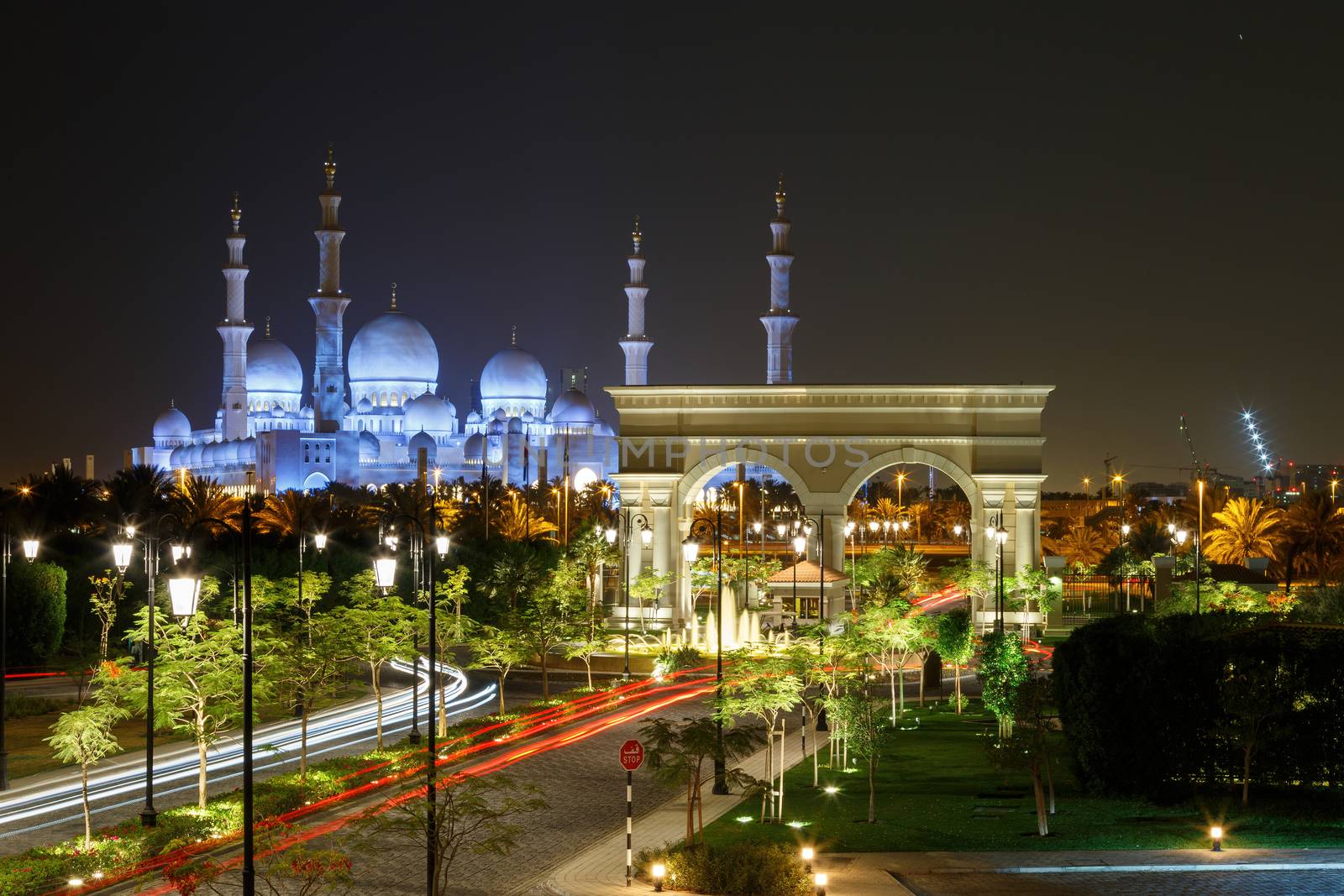 Abu Dhabi, UAE - CIRCA 2020: Beautiful view of Sheik Zayed Grand mosque. Night view of mosque with colorful illumination. Concept of Islam faith and spirituality by dugulan