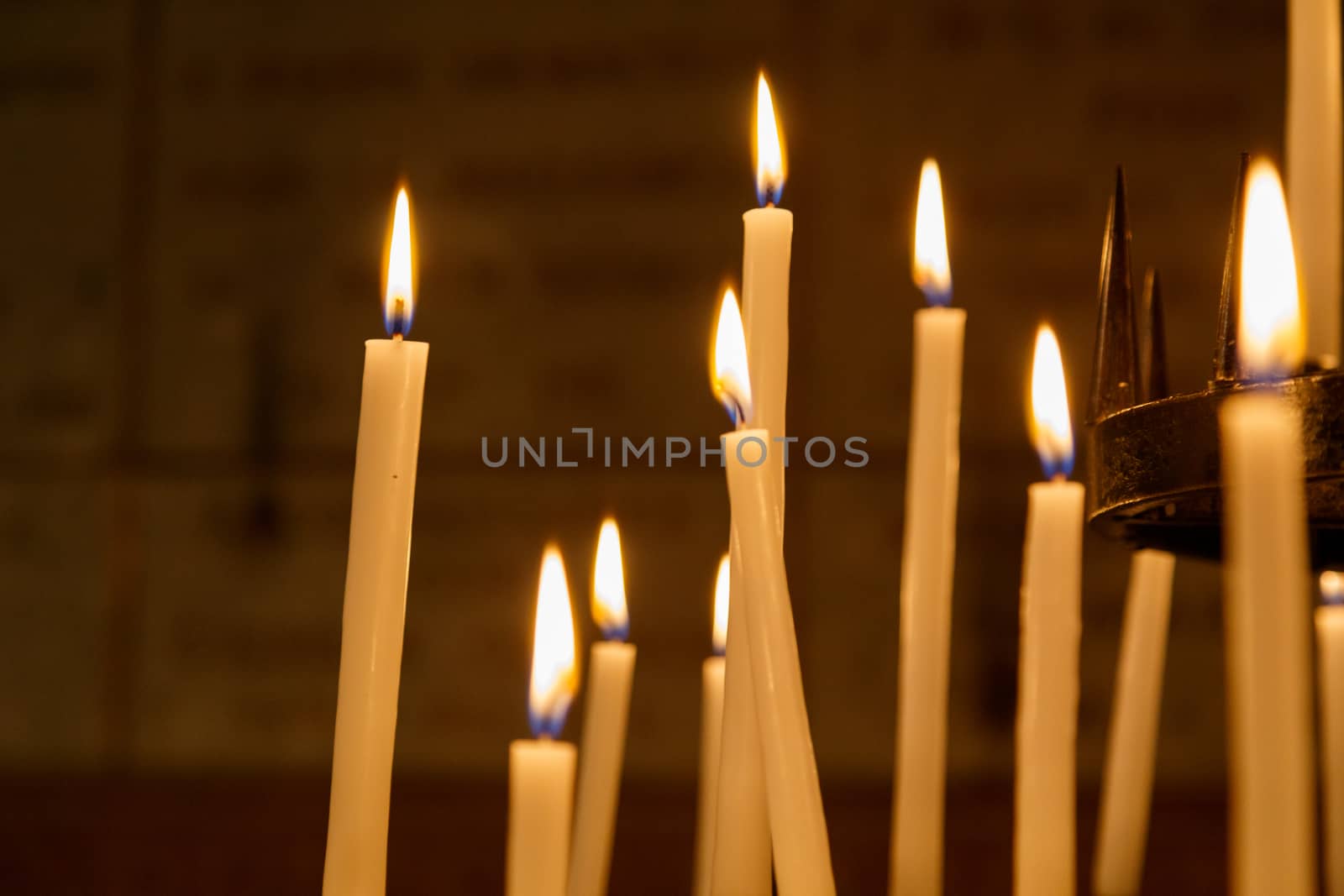 Light from candles in the church on the black background. Concept of spirituality and faith.