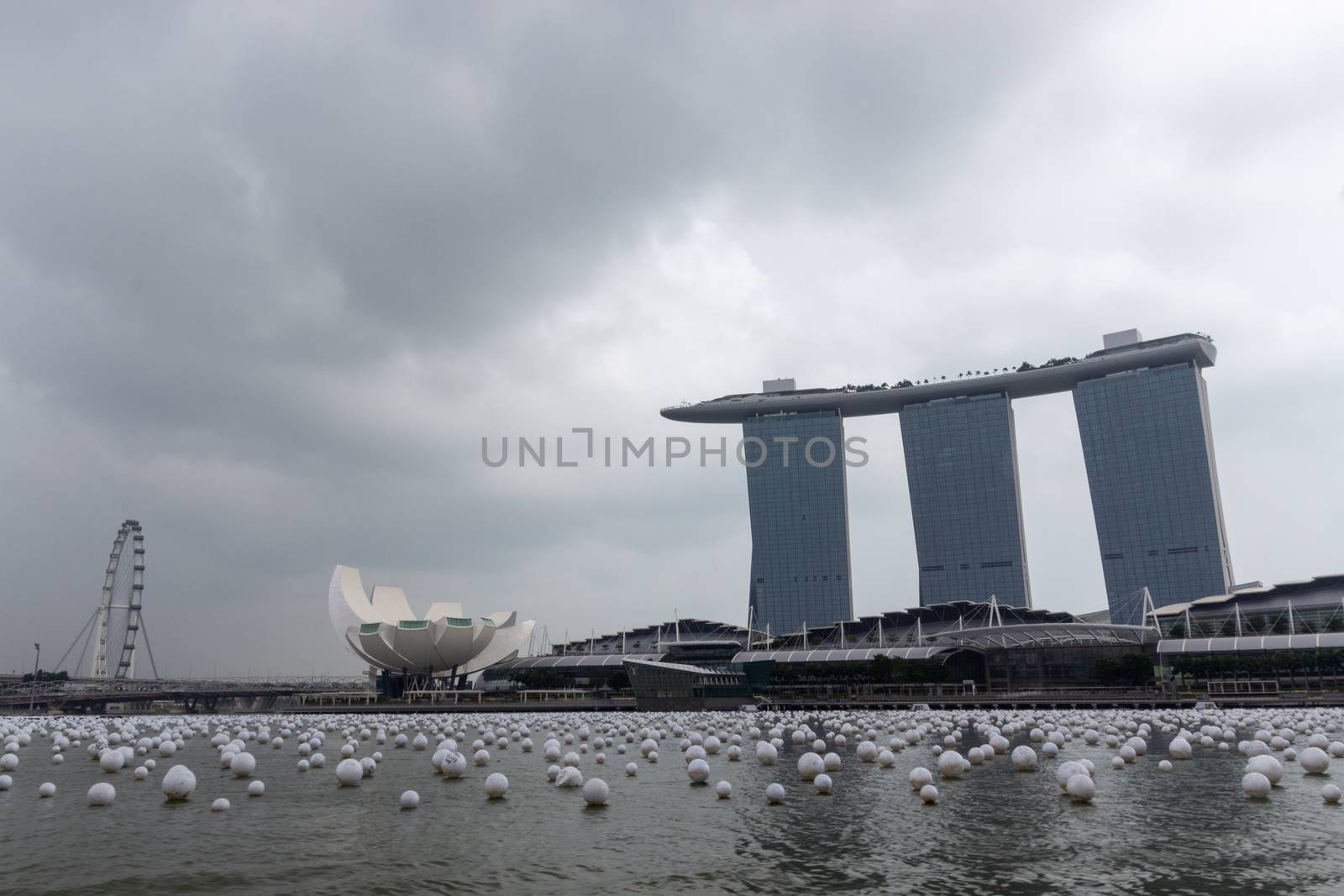 Singapore - CIRCA 2020: Skyline in Marina Bay, view of Art Museum, famous hotel and Singapore Flyer during the day with a stormy sky on the background. by dugulan