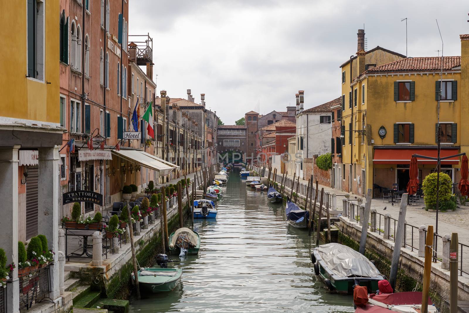 Venice, Italy - CIRCA 2020: View of an empty water canal in Venice Italy. Concept of the effects of lock down due to CoronaVirus COVID-19. Picturesque landscape. by dugulan