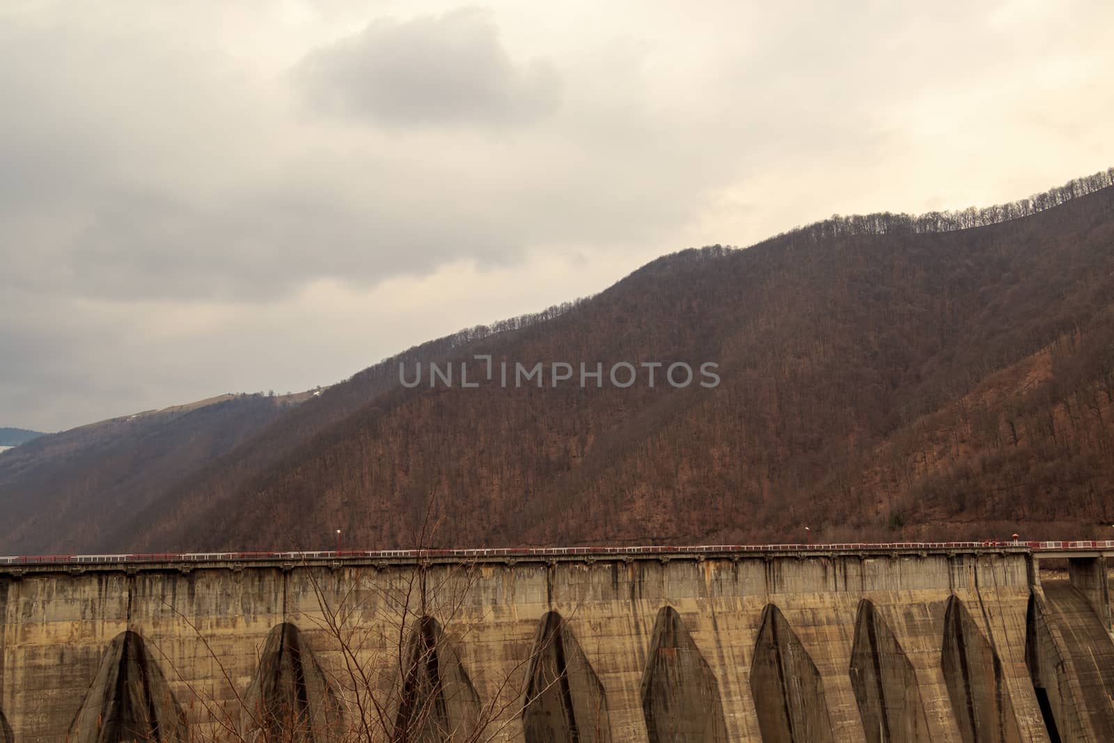 Gura Raului, Romania - CIRCA 2019: View of Gura Raului dam in Romania during autumn with beautiful colors. Concept of hydroelectric power and clean energy. by dugulan