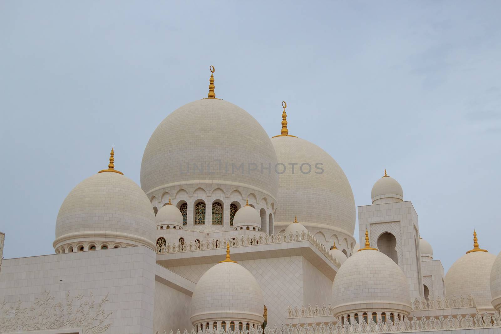 Abu Dhabi, UAE - CIRCA 2020:Sheikh Zayed Grand Mosque in Abu Dhabi, exterior view during the sunset located at the capital city of United Arab Emirates. The beautiful and largest mosque in Middle East by dugulan