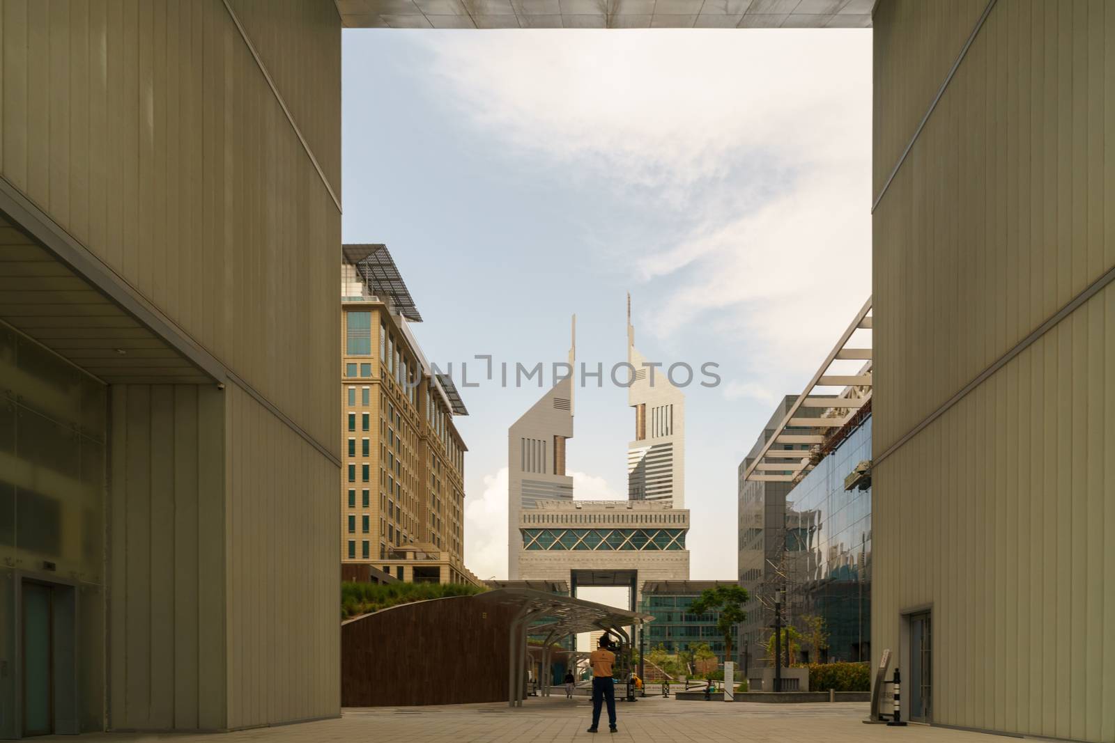 UAE, DUBAI, CIRCA 2020: Dubai Financial center district. View of The Gate and Jumeirah Emirates Towers in DIFC. Day view with cloudy sky by dugulan