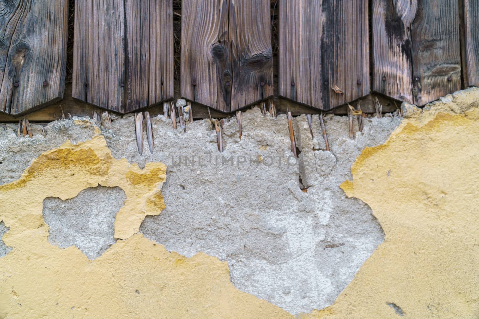 Grungy old yellow brick wall and old wood texture background with deterioration from age