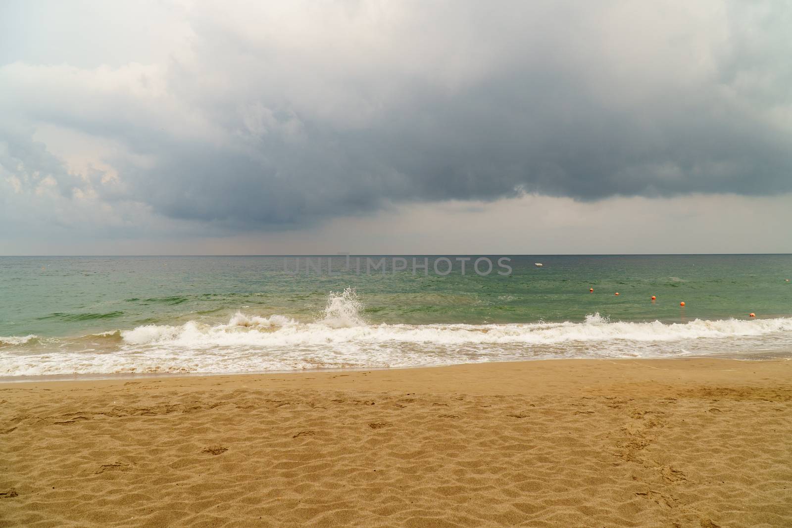 Storm clouds over a rough sea in Fujairah, UAE. Concept of bad weather, hurricane season and storm unstable times