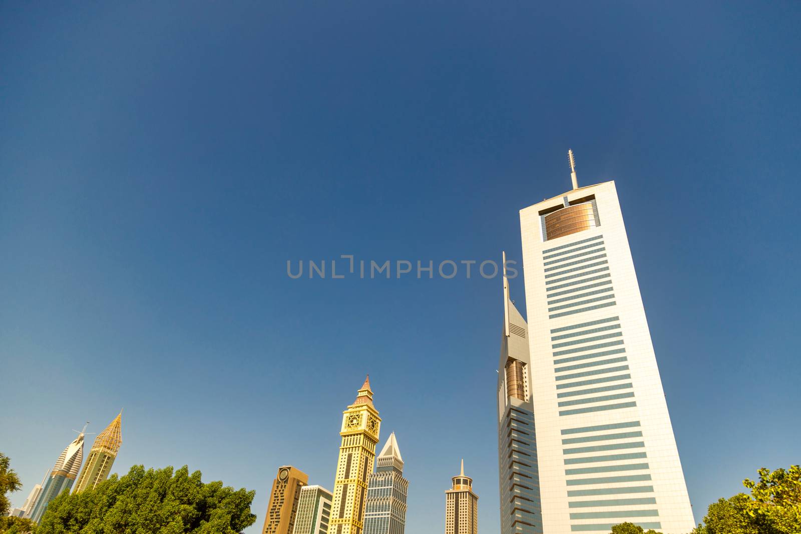 UAE, DUBAI, CIRCA 2020: Dubai Financial center district. View of The Jumeirah Emirates Towers in DIFC. Day view with clear sky