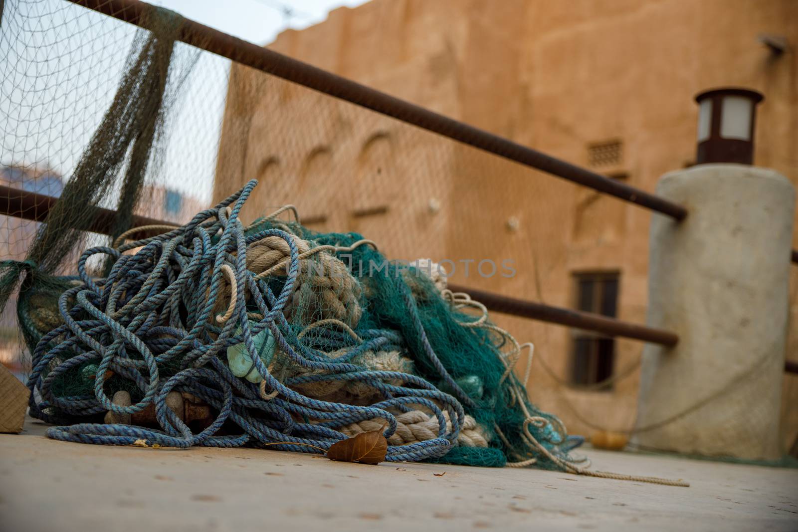 Fishing nets, buoys and floats on pavement not being used in old town Dubai by dugulan