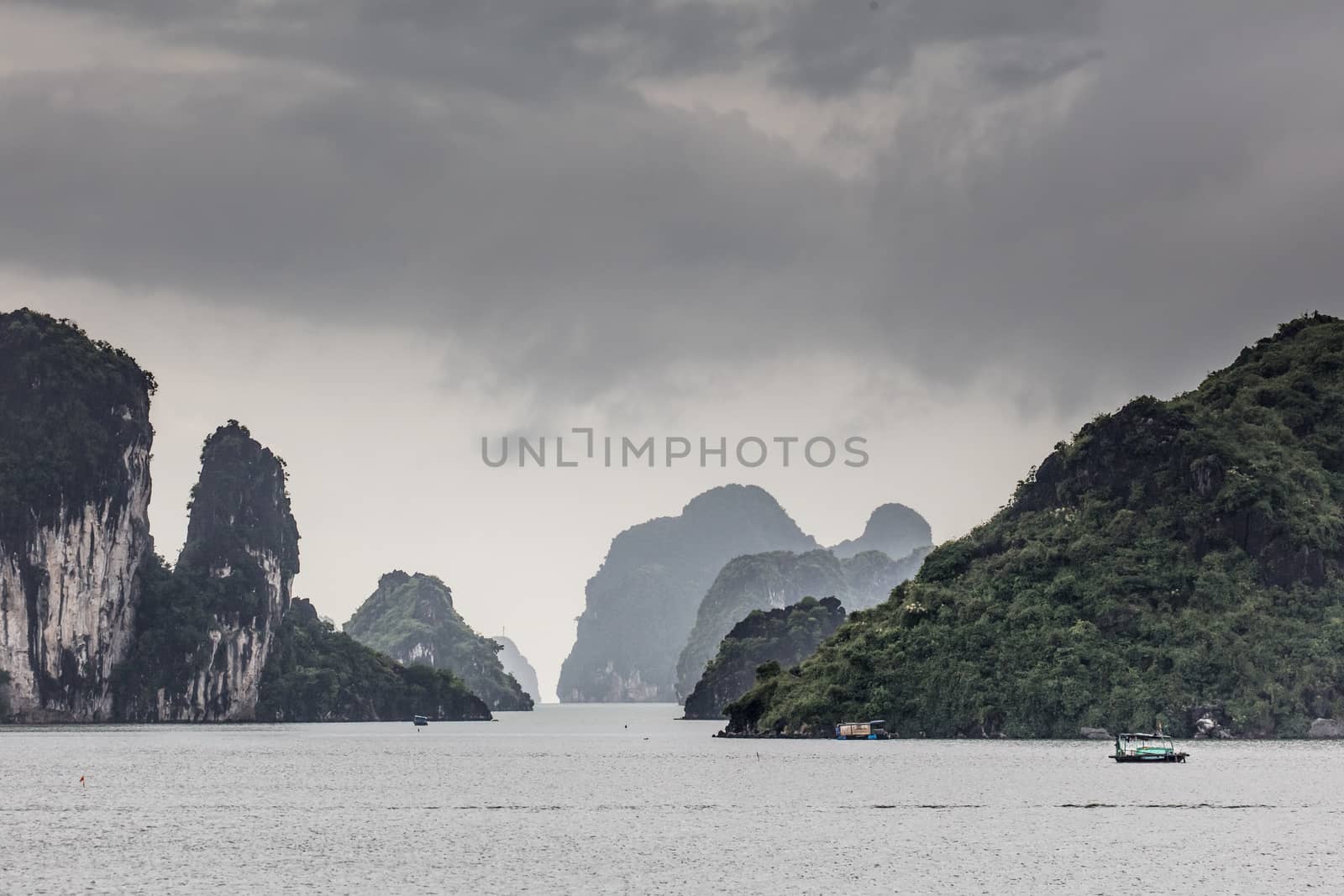 View throughout the islands of Ha Long Bay on a stormy summer's day in Ha Long Bay, Vietnam