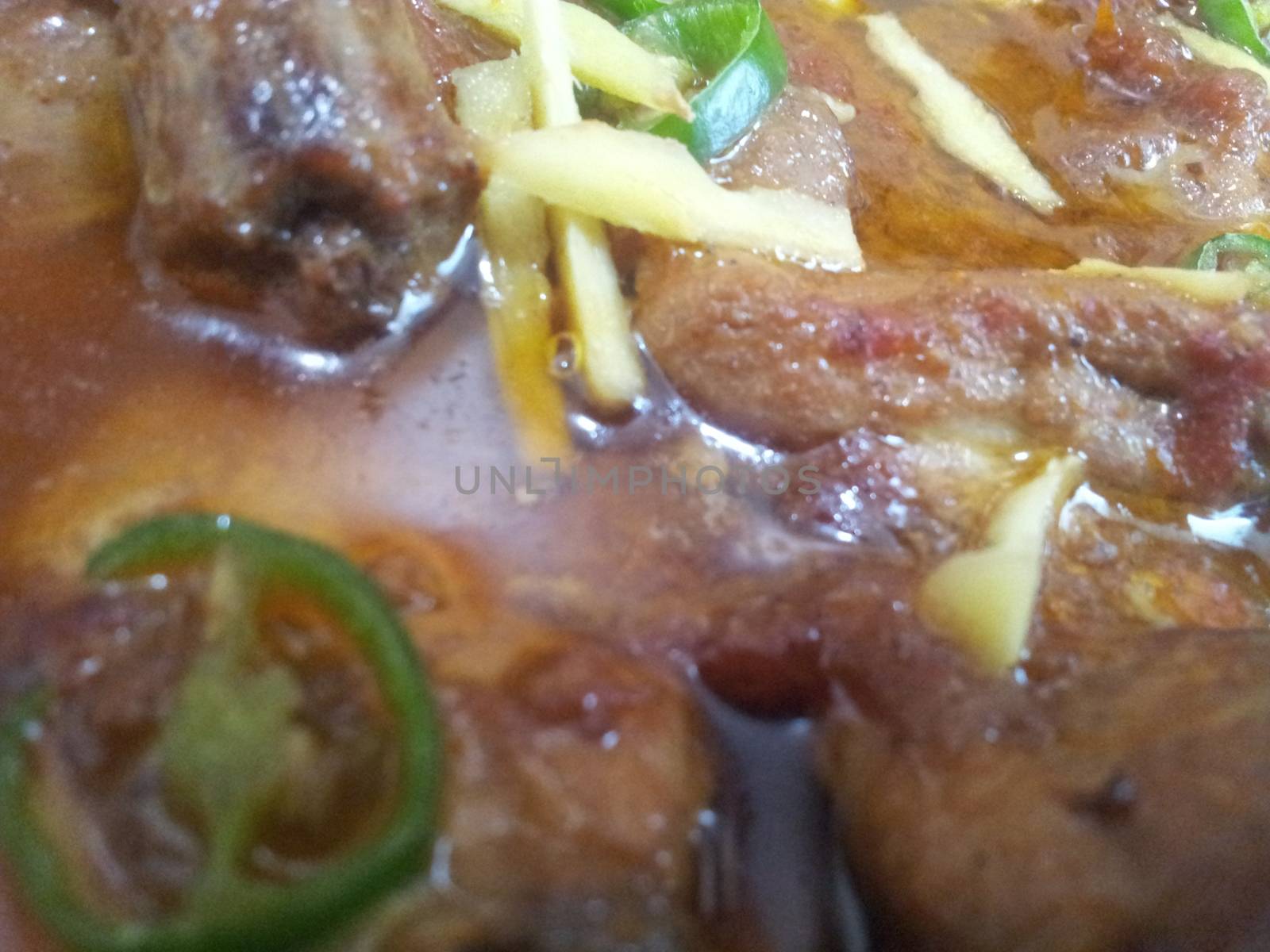 Delicious traditional haleem dish with blackish fried onion rings in a bowl, for dinner / lunch