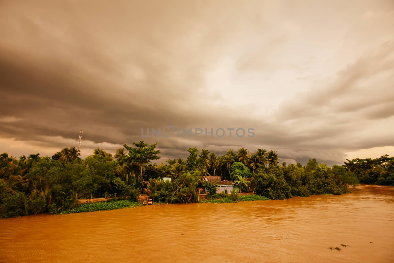 A stunning sunset with storm in the distance on the Mekong River near Can Tho in Vietnam