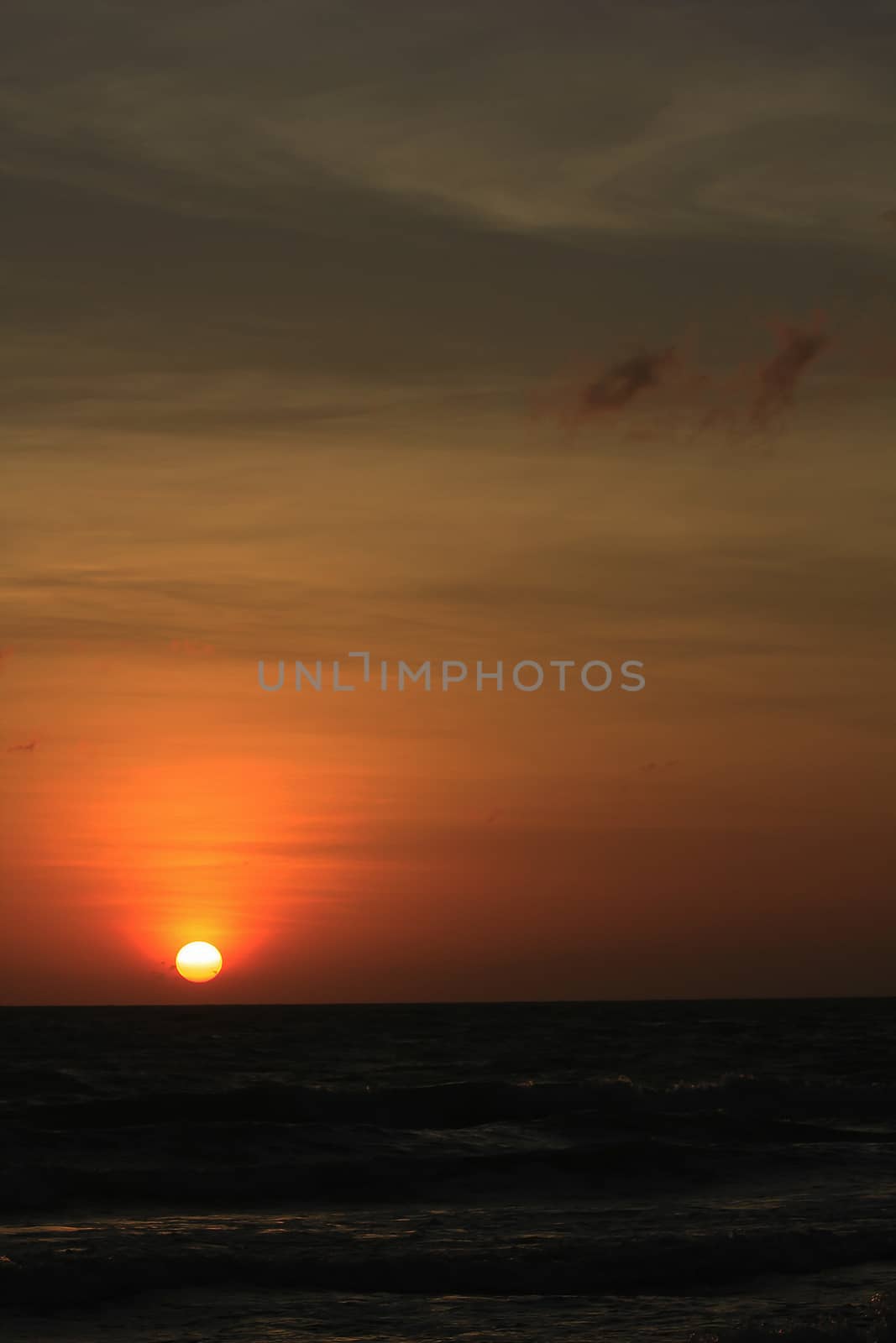 The morning sunrise over the horizon in the sea