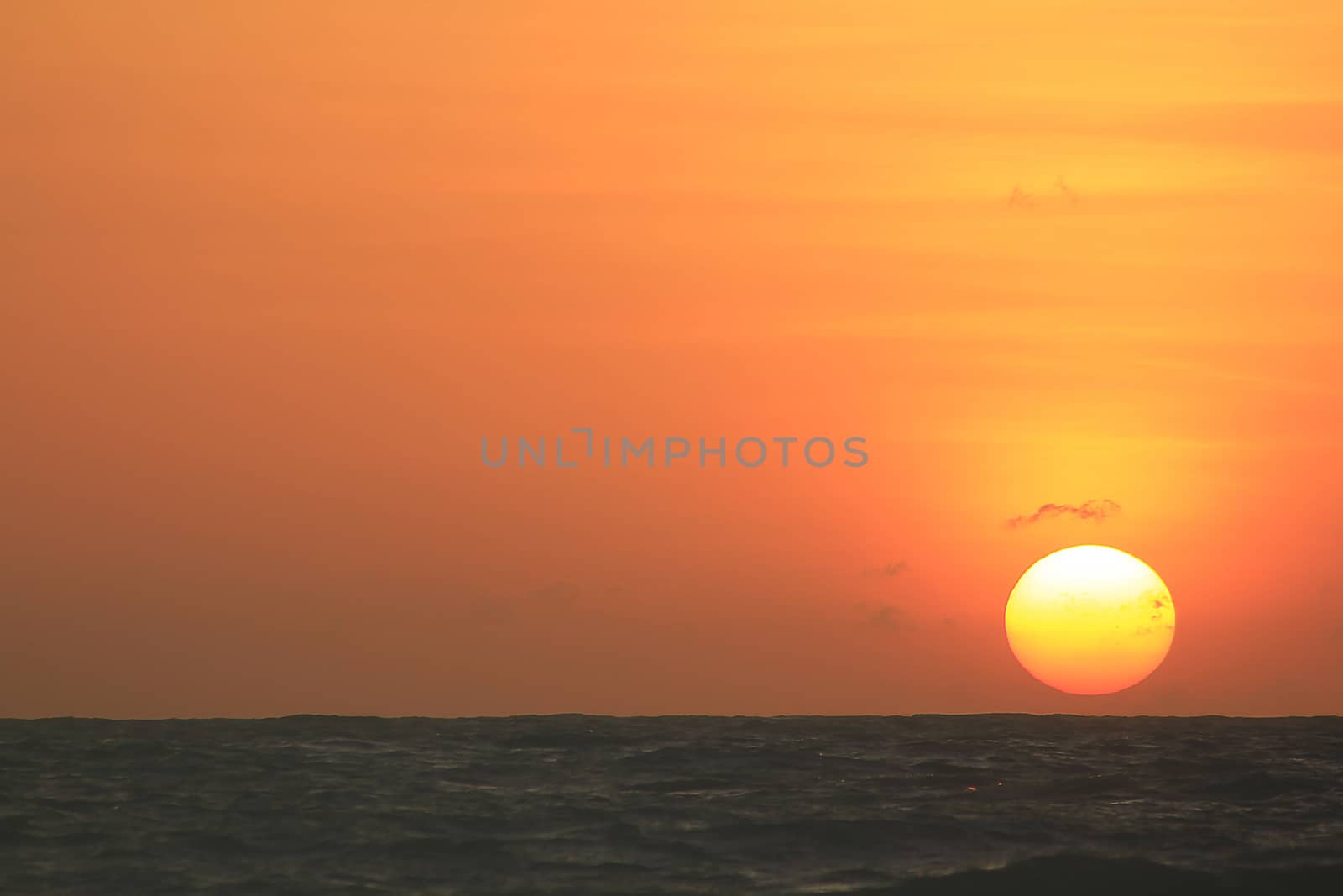 The morning sunrise over the horizon in the sea