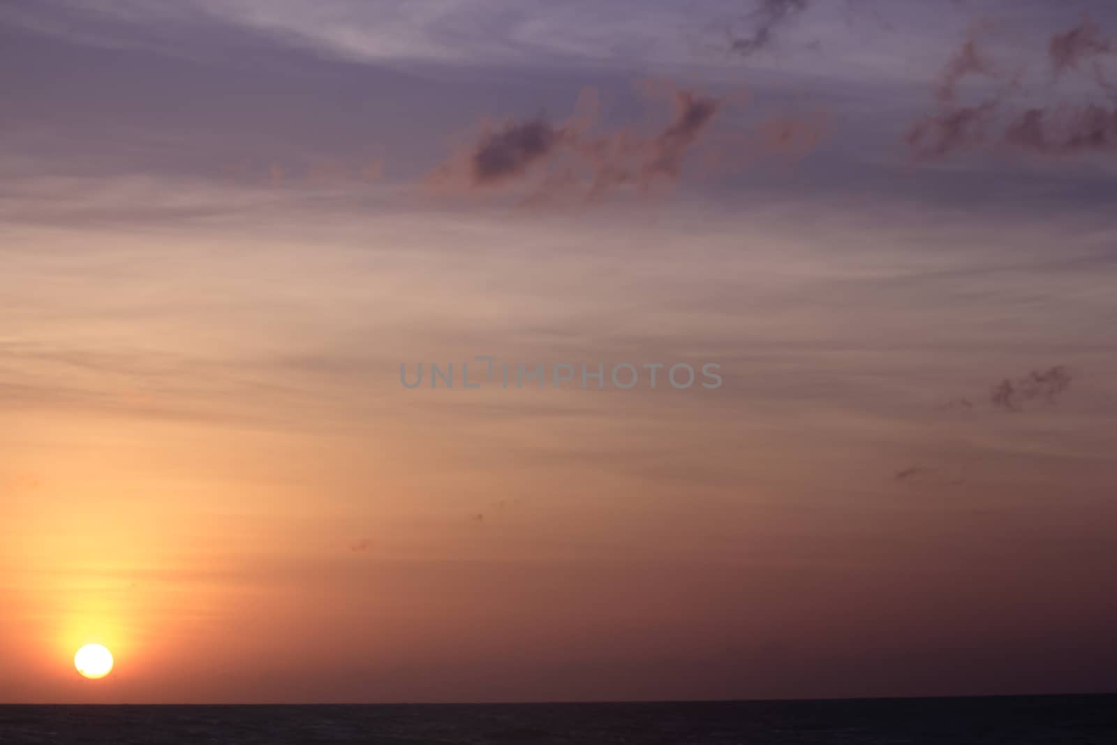 The morning sunrise over the horizon in the sea