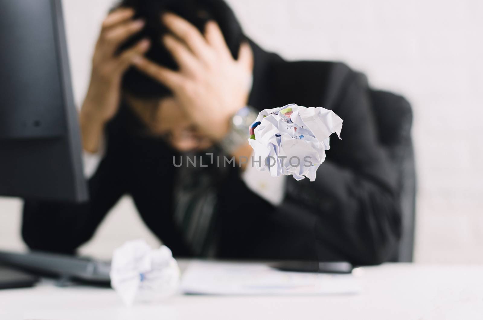 businessman emotions and fail concept crumpled paper on table wi by sompongtom