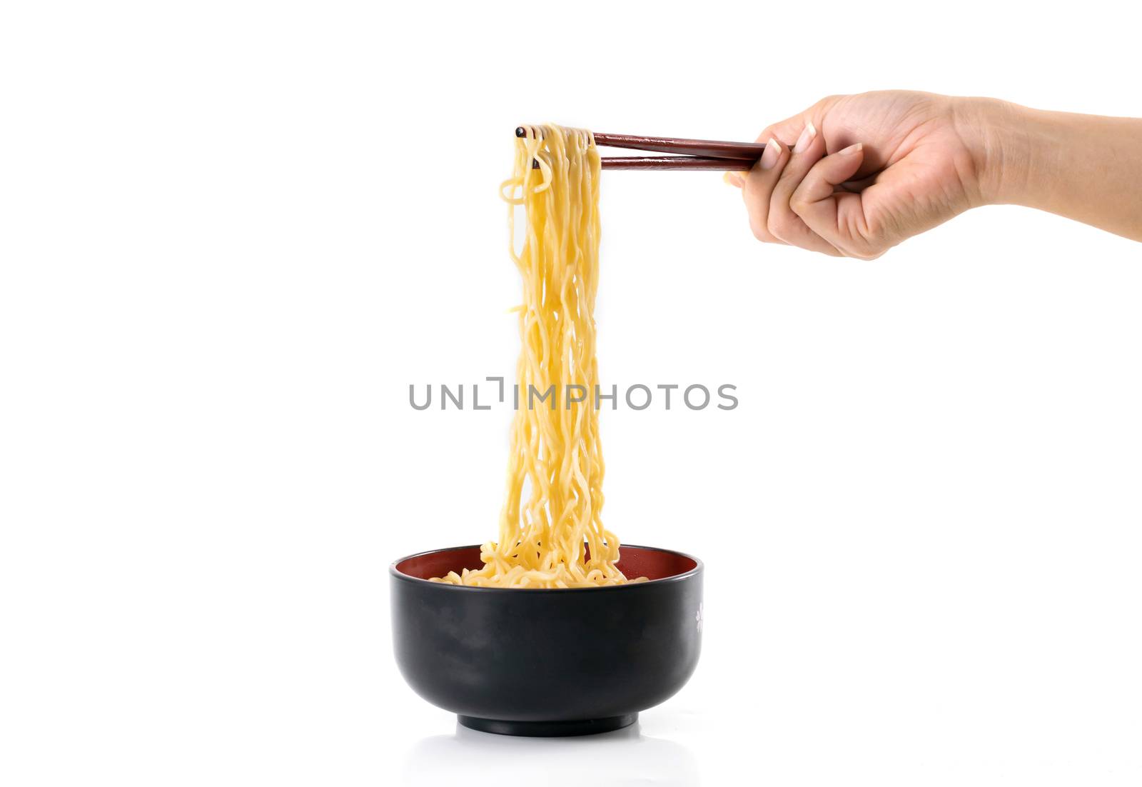 noodle chopsticks in a black bowl on a white background by sompongtom